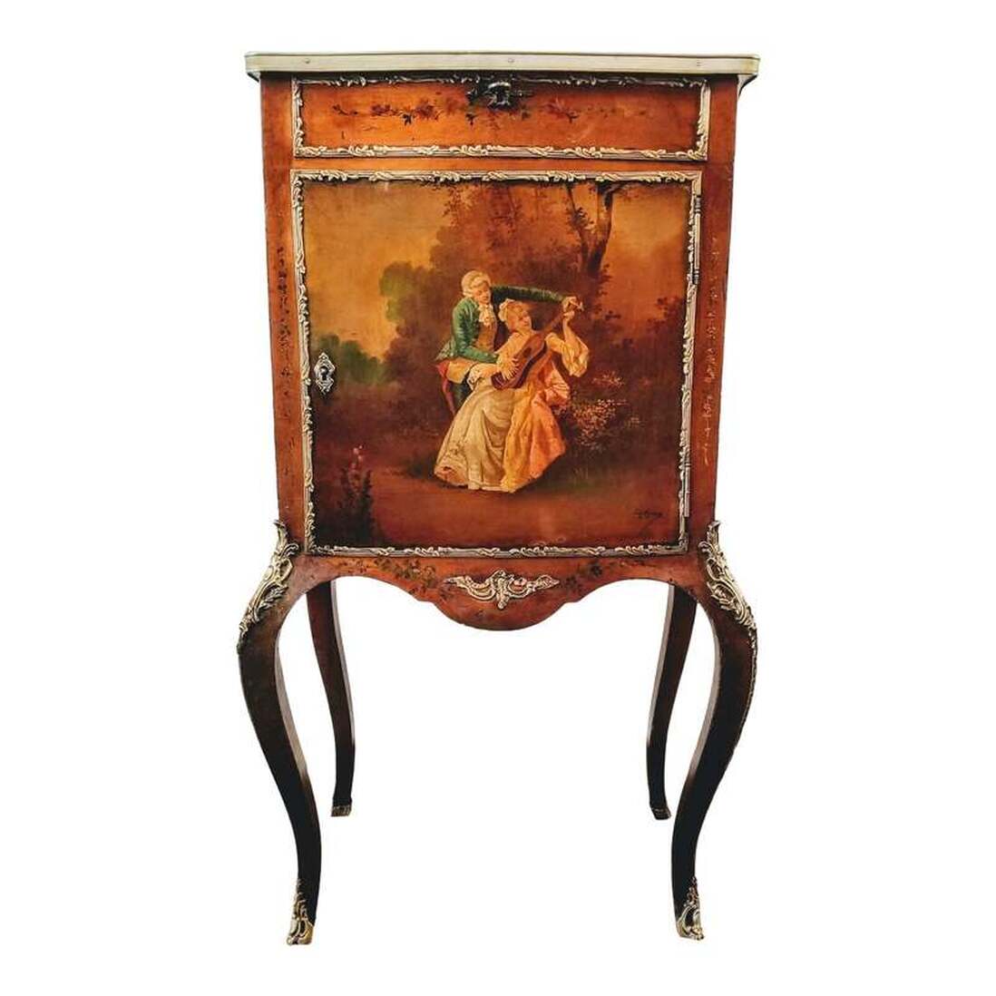 1885-1890s jewelry vitrine is decorated with Rococo scenes and flowers painted by Ch. Olivier. The shaped top has a beveled glass insert set into a wood frame decorated with painted flowers. The lid is hinged and opens to reveal a pink velvet lined interior in which to display your jewelry and romantic keepsakes. A latch resembling a key turns to open and secure the lid and may be seen on the front on the faux drawer front at top. The locking cabinet door opens to reveal a wood interior with a single shelf for storage. The painting on the front of the door showcases a young lady who appears to be receiving a guitar playing lesson. The beveled glass insert, faux drawer, and painted door are all framed with gilt bronze trim. Gilt bronze ormolu mounts protect the knees and feet of the cabriole legs. The side panels are painted with florals at top and beautiful country scenes below, both paintings framed with gilt bronze trim. The back is decorated with a painting of flowers framed at the top corners by leafy swags. Vitrine has a faux craquelure over a vernis Martin finish.