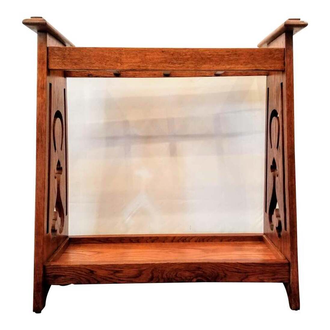 Early 20th-century arts & crafts hall stand for canes, umbrellas, parasols, walking sticks, and swagger sticks. Designed and manufactured in England from brown oak wood. The sides feature decorative cutwork featuring an upside-down horseshoe to rain your gathered luck upon your household!