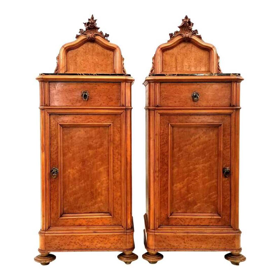 Antique pair of somnoe, or half commodes, are ideal for use as bedside cabinets or nightstands. The pair was made in Northwestern Italy between the 1830s and the 1870s during the Rococo Revival period of the nineteenth century. The nightstands are constructed of Birdseye Maple wood and trimmed with burled maple wood. The nightstands are topped with Portoro limestone from Porto Venere, Ligeria, Italy ( also from La Spezia and Lerici on the Italian Riviera ), where it has been quarried sporadically since the 16th century and exported worldwide. The limestone is black with white calcite filled veins and stylolites and sinuous wider veins and pods of yellow calcite colored by geothite ( iron hydroxide ). Above the limestone tops are carved rocaille crests, reminiscent of the German muschelwerk, featuring scrolls and foliates. On either side of the crests are scroll and leaf supports. The corners are rounded and the stiles are molded cyma curves, both popular features in France during the reign of Louis-Philippe ( 1830 - 1848 ). The top drawers show hand cutting, planing, and dovetailing on the fronts and backs. The bottom cabinet interiors each feature one shelf and are accessed by opening the inset panel single doors. Under the bottom front are turned bun feet and under the back are block feet. Cabinets will complement interiors decorated with elements of Louis-Philippe, Biedermeier, French Rococo, Venetian Baroque, Victorian, and Italian Grotto. Size: 20
