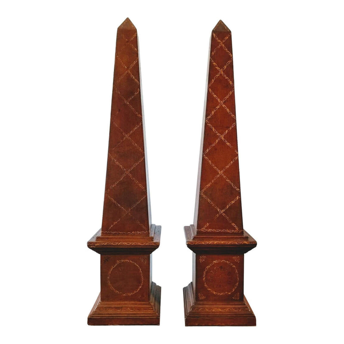 Pair of embossed leather obelisks were manufactured for the designer decor market in the late 20th century. The leather has been given an aged finish to replicate the patina of antiques.  SIZE:  7.25