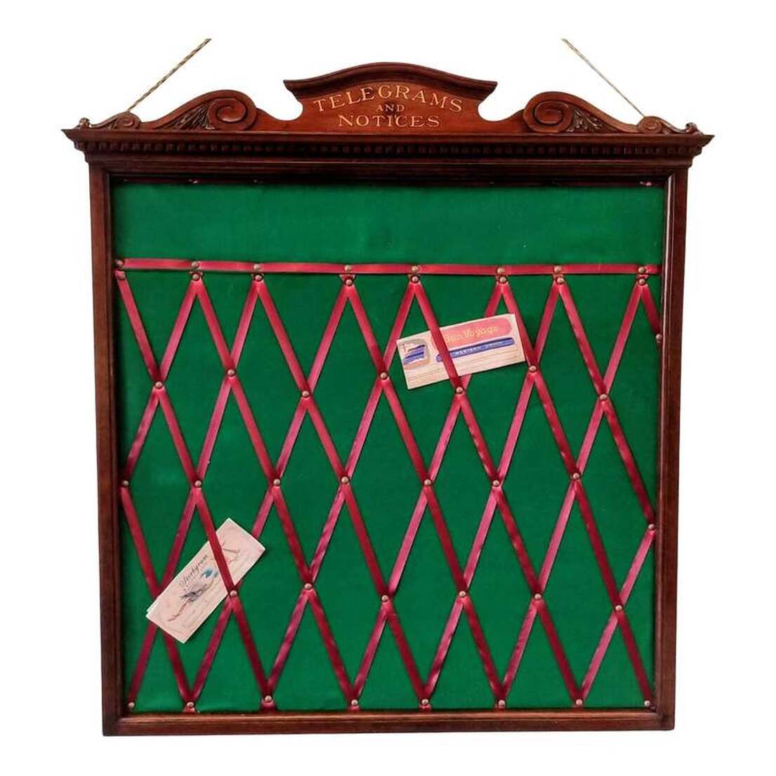 Telegrams and Notices board from late-Victorian England.Neoclassical style mahogany wood frame surrounds a center of new felt and ribbon. Under the bonnet top with scrolls and acanthus leaves is lettering spelling 