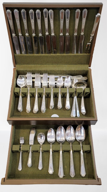 Silver plated flatware set stamped "1847 Rogers Bros." in the Ancestral pattern, introduced in 1924. Knives, spoons, forks, and serving utensils shown in flatware box.